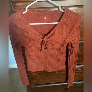 Long sleeve shirt. Tie in the front.